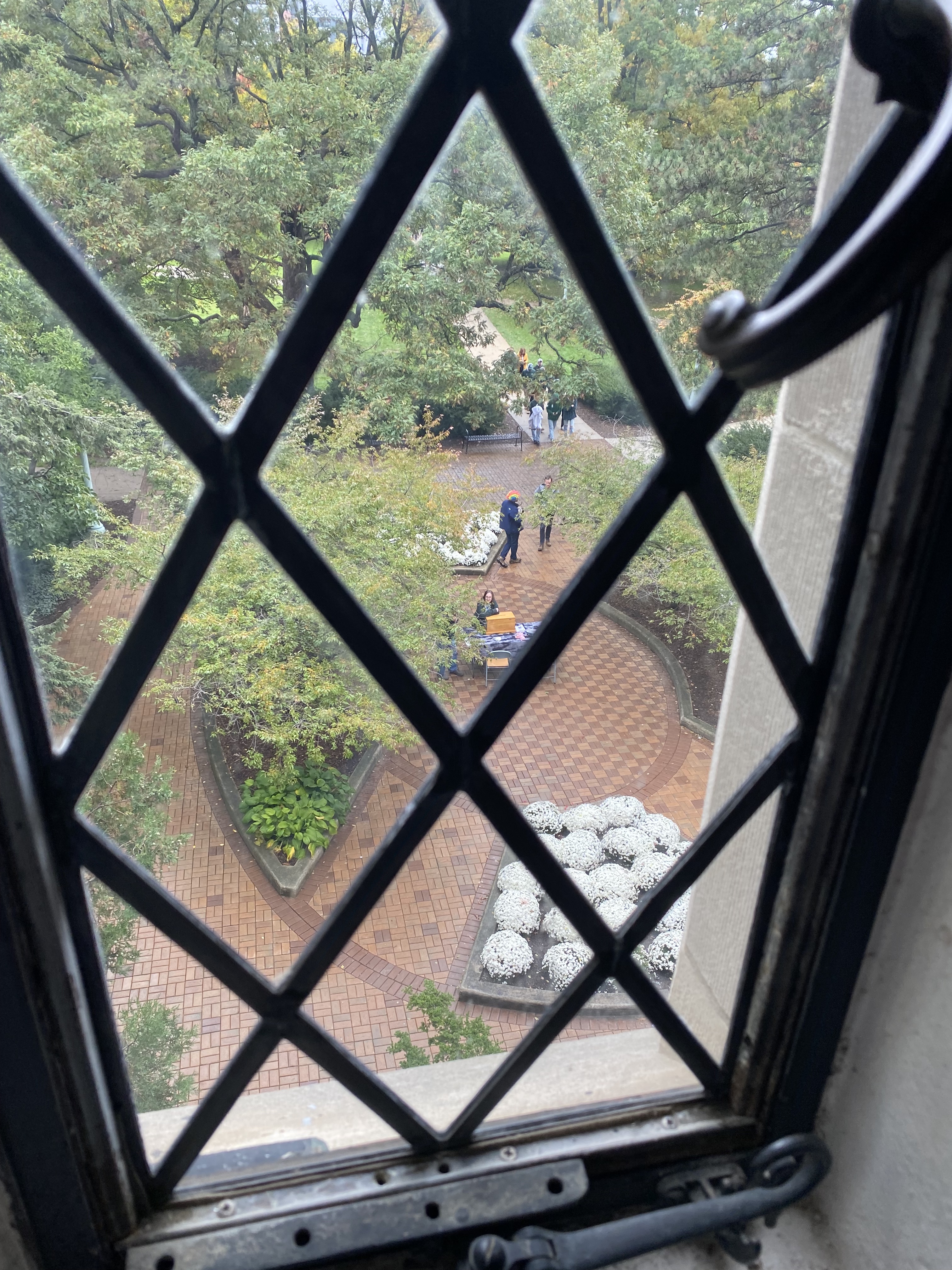 Image shows a view down through a window to a courtyard below