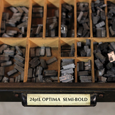 A drawer of metal type pieces.