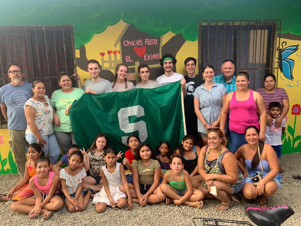 RCAH students CR with MSU flag