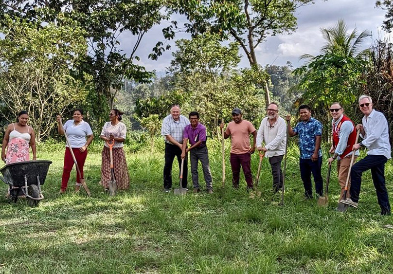 A group of ten people stand in a loose semi-circle with shovels in hand. Present are Vincent Delgado, Dean Dylan Miner of RCAH, Senior Associate Dean Thomas Voice and First-Year Engineering CoRe Experience Director Timothy Hinds