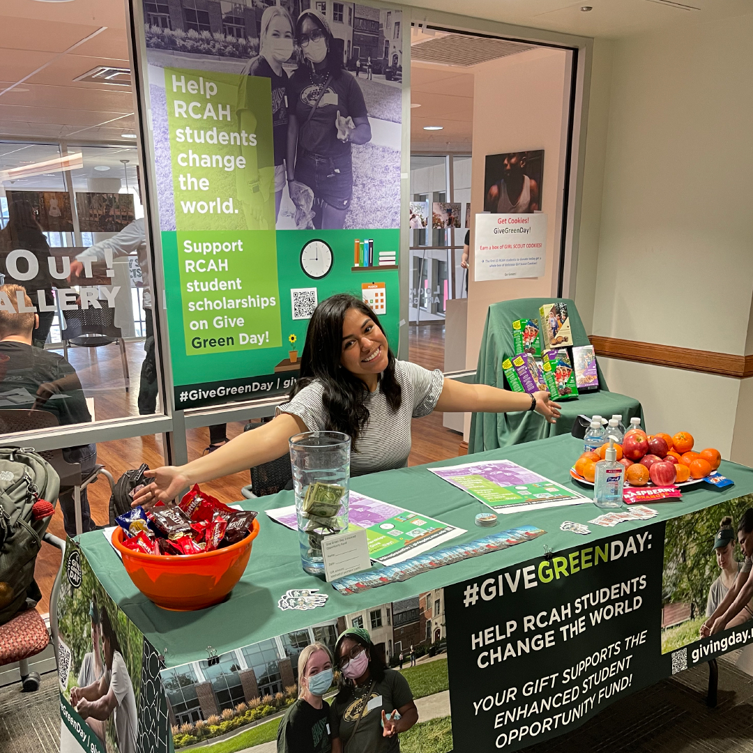 RCAH sophomore Esli Mendoza working the Give Green Day table in Snyder Hall to collect donations for the scholarship fund.