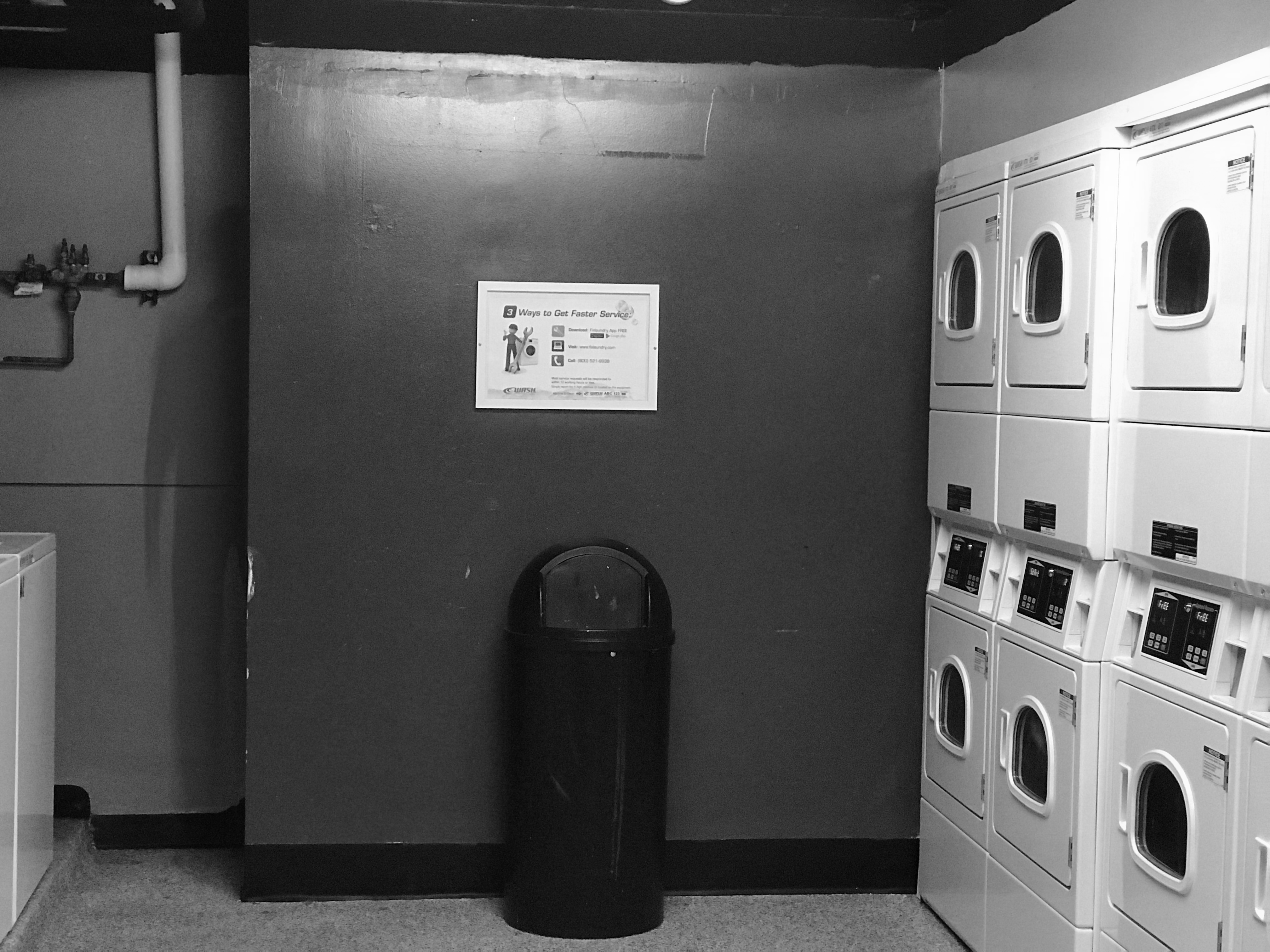 Image shows a hallway in a dorm room. At the end of the hallway is possibly a shadow person. Or photoshop.